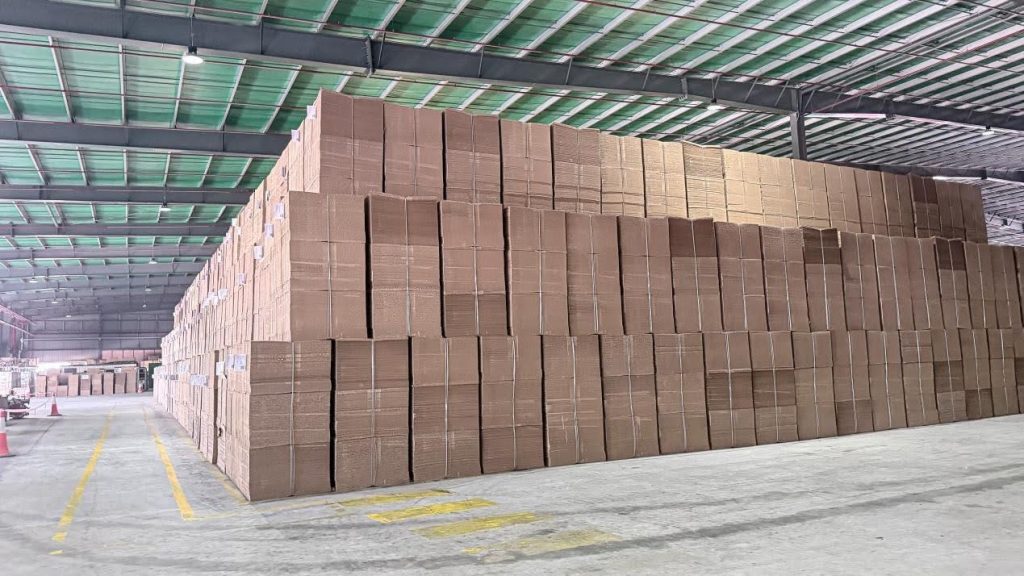 Stacks of recycled pulp bales stored inside the JX Papers warehouse.
